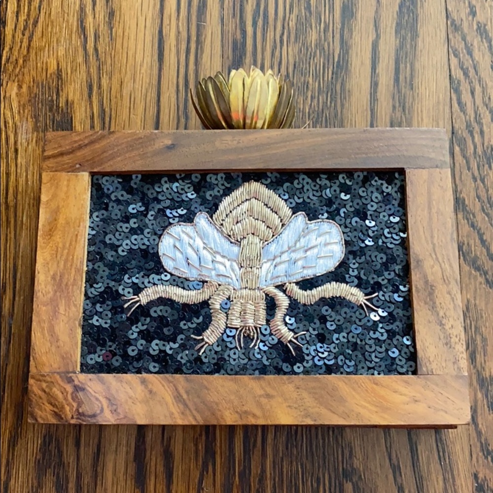 Wooden evening bag with brass flower closure